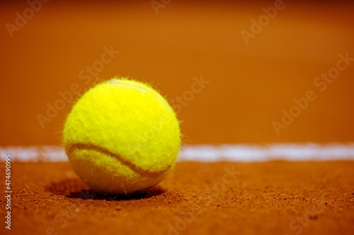 Tennis ball on the tennis court. Gravel. Tennis game. Sport, recreation concept © Dmitry