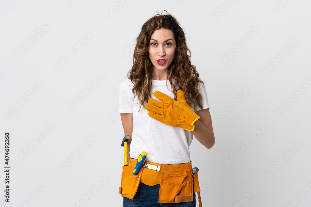 Young electrician man isolated on white background surprised and shocked while looking right Young electrician man isolated on white background surprised and shocked while looking right