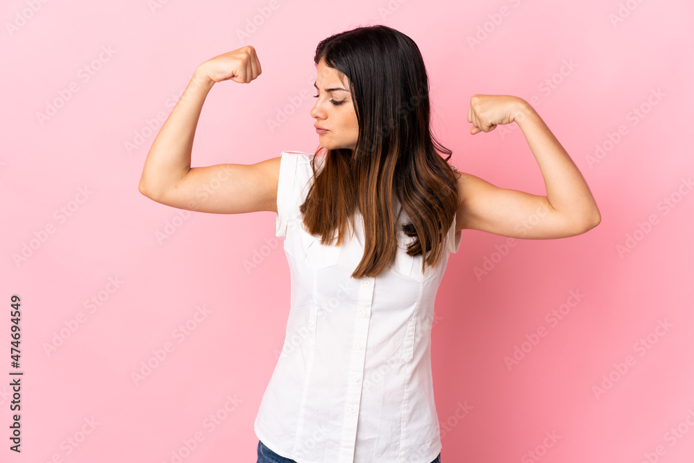 Young caucasian woman isolated on pink background doing strong gesture Young caucasian woman isolated on pink background doing strong gesture