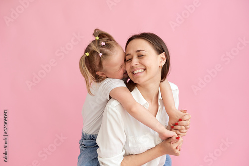 The daughter gives a kiss to her mother on the cheek. Mother's day concept, mother and daughter love