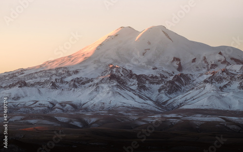 Beautiful photography of the snowy mountain Elbrus. Autumn weather, nature travel in Russia. Sunny outdoor scenics.