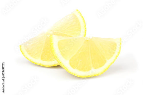 Two wedges of fresh lemon on white background