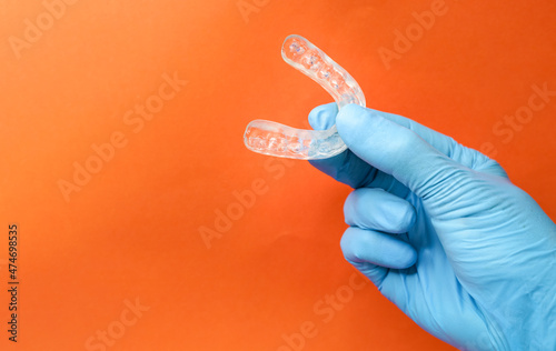 doctor holding a dental retainer or dental splint photo