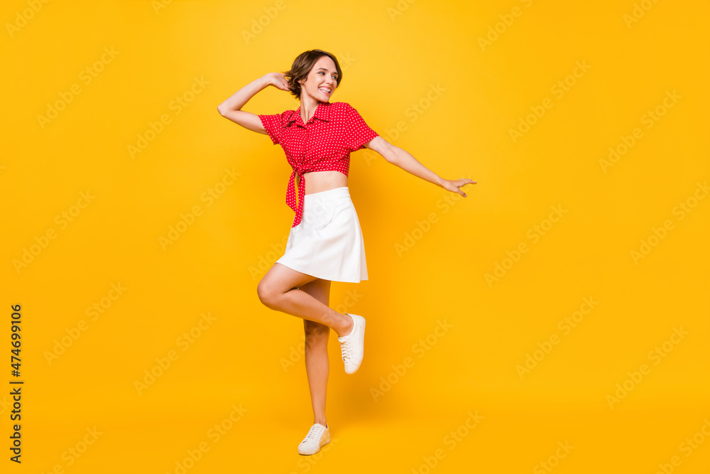 Full size photo of optimistic nice brunette lady look empty space wear shirt skirt isolated on yellow color background