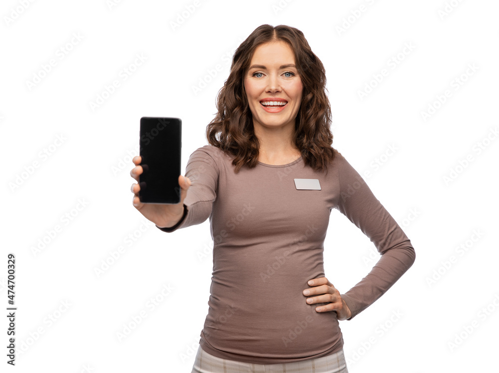 sale, shopping and business concept - happy female shop assistant with name tag showing smartphone over white background sale, shopping and business concept - happy female shop assistant with name tag showing smartphone over white background