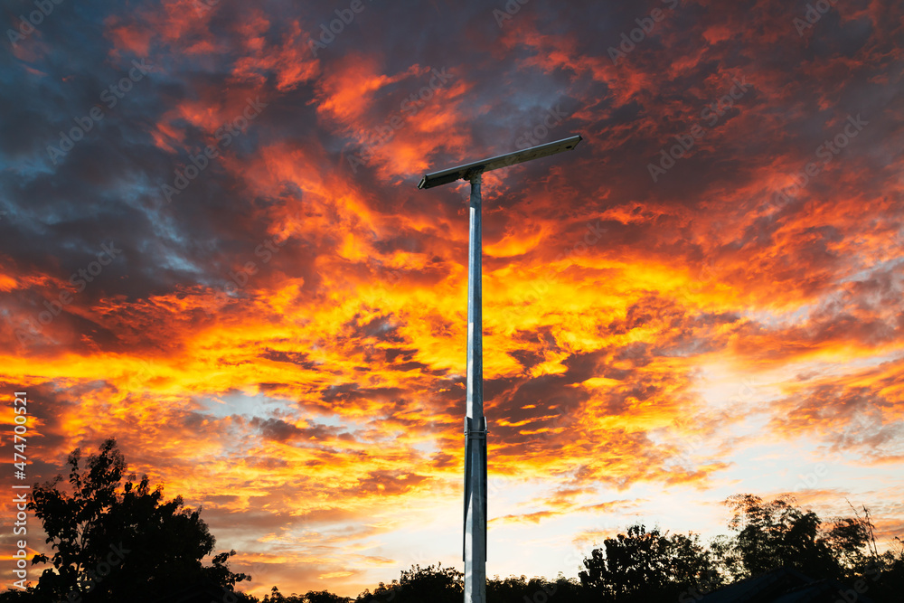 Solar cell street lamp pole on oranges sky . background of sunset Solar cell street lamp pole on oranges sky . background of sunset