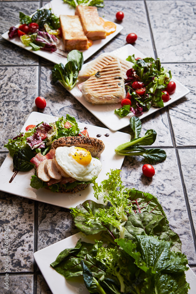 Sandwich and fried egg, fresh vegetables, variety of brunch Sandwich and fried egg, fresh vegetables, variety of brunch