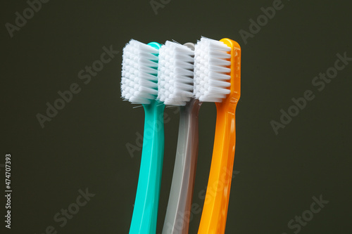 Kiev, Ukraine - December 13, 2021: Curaprox CS 5460 Ultra Soft bright toothbrushes in a glass beaker on a black background
