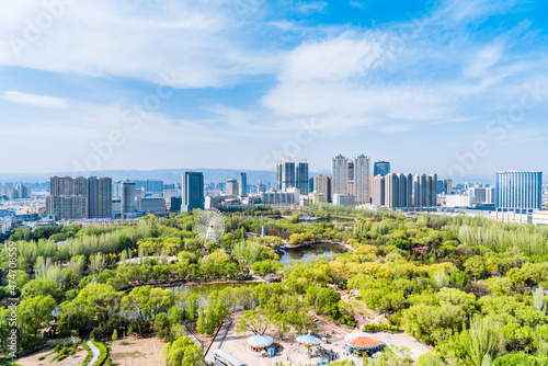 Ferris wheel and city skyline scenery in Qingcheng Park, Hohhot, Inner Mongolia, China