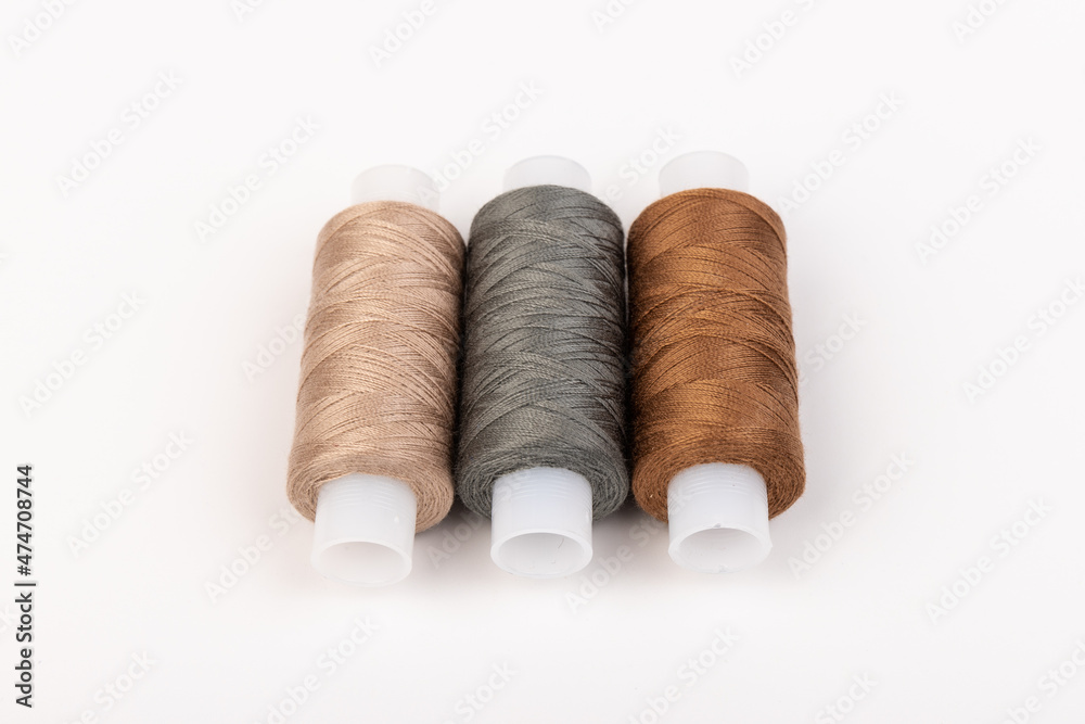 Color sewing threads isolated on white background. Different colors.Bright bobbin thread. Color sewing threads isolated on white background. Different colors.Bright bobbin thread.