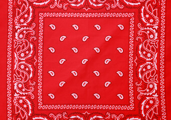 Top view of red bandana with paisley pattern as background