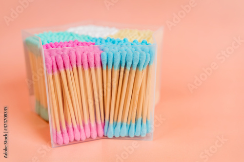 A box with colorful cotton swabs for cleaning ears. Hygiene concept