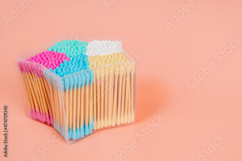 A box with colorful cotton swabs for cleaning ears. Hygiene concept