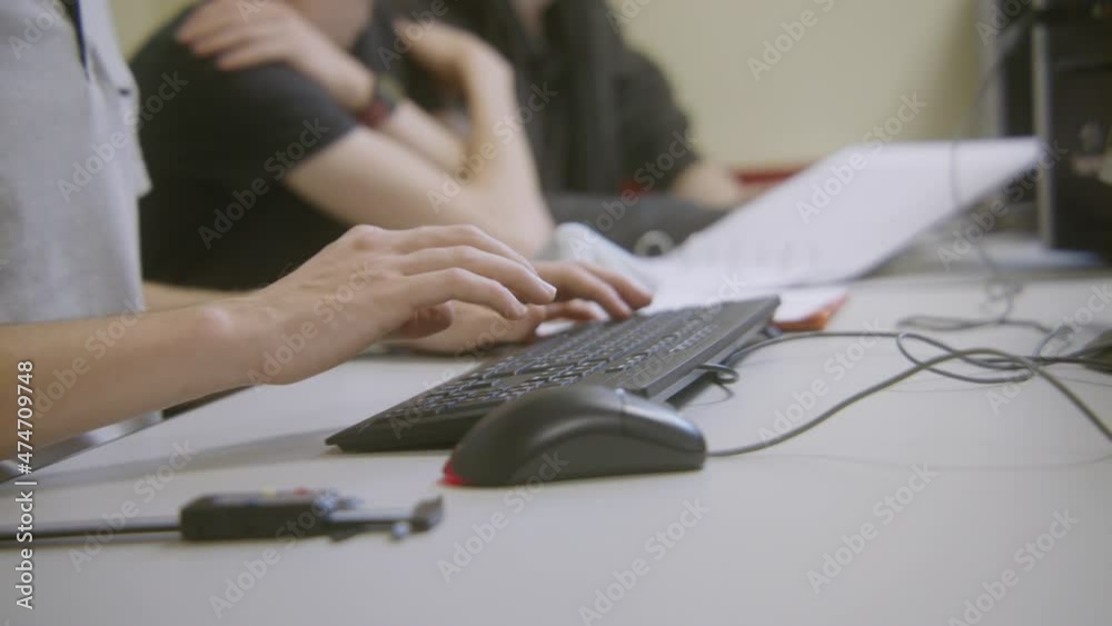 Students working on computers and keyboards in a french international school.