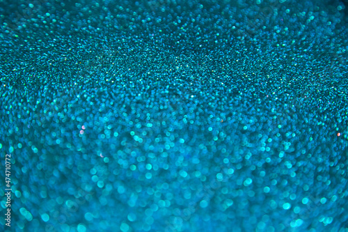 Abstract shiny blurred blue background with bokeh lights. Selective focus. Holiday.