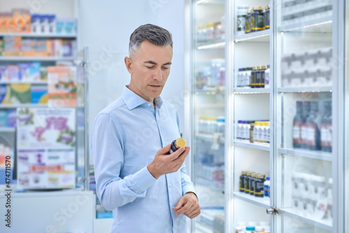 Wallpaper Mural A man choosing medicines in a drugstore Torontodigital.ca