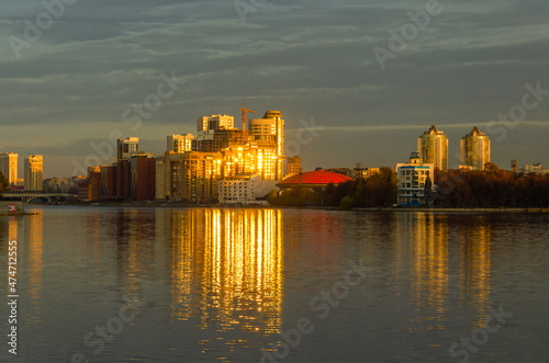 High-rise buildings on the river bank at dawn.