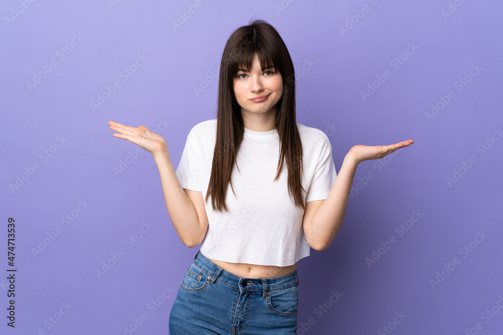 Young Ukrainian woman isolated on purple background having doubts while raising hands Young Ukrainian woman isolated on purple background having doubts while raising hands