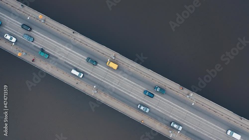 Urban car traffic on the bridge over the river. Shooting with a drone. photo