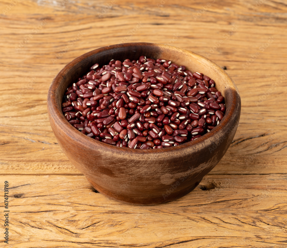 Azuki beans in a bowl over wooden table Azuki beans in a bowl over wooden table