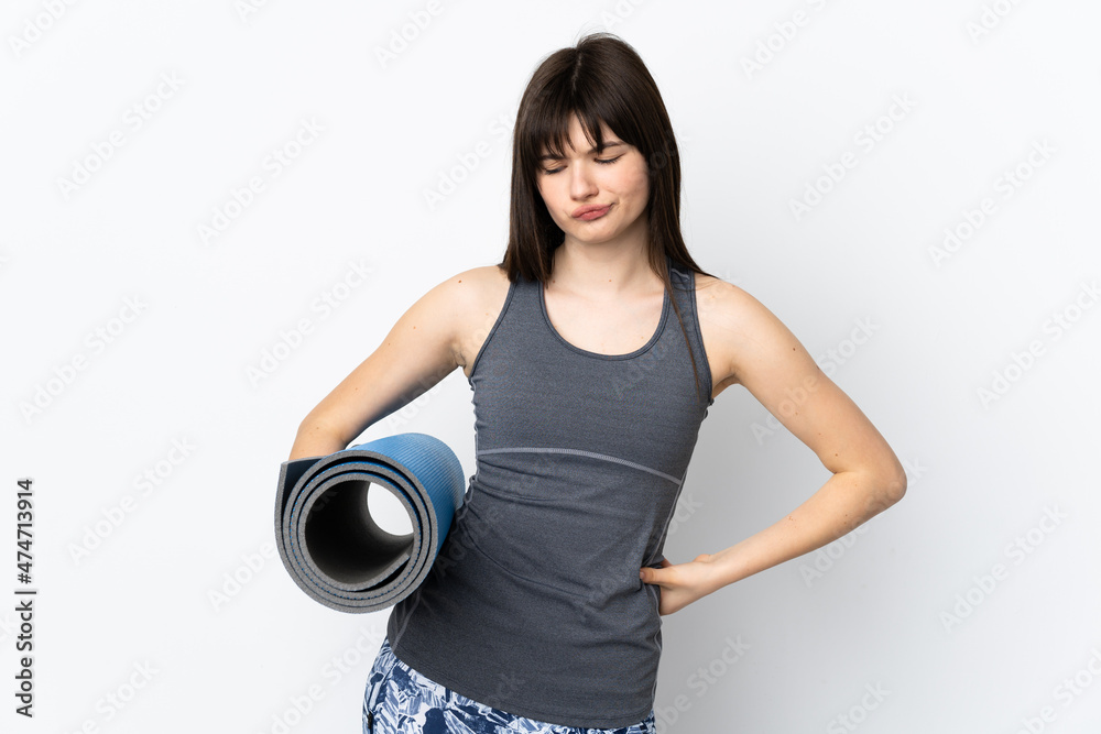 Ukrainian sport girl with mat isolated on blue background with sad expression Ukrainian sport girl with mat isolated on blue background with sad expression