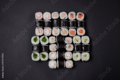 a portion of different rolls on the table, japanese food, sushi set on marble, top view, chinese chopsticks