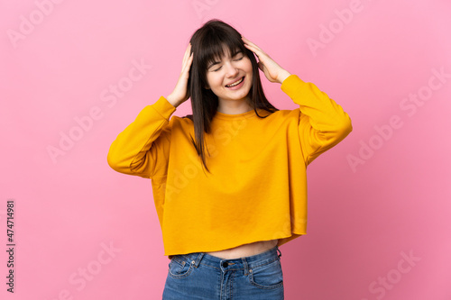 Young Ukrainian woman isolated on pink background laughing