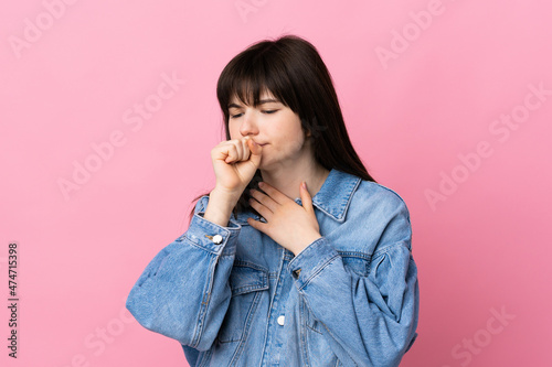 Young Ukrainian woman isolated on pink background coughing a lot