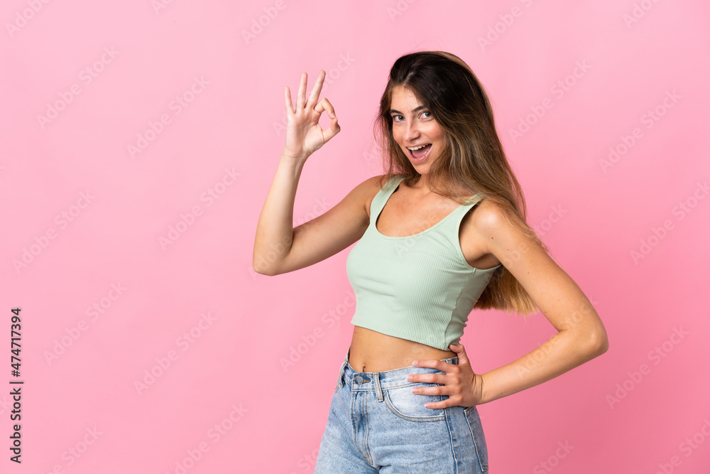 Young caucasian woman isolated on pink background showing ok sign with fingers Young caucasian woman isolated on pink background showing ok sign with fingers