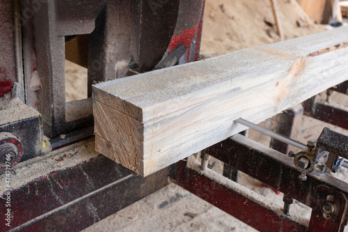 Processing wooden boards at a sawmill. Sawing logs at a sawmill