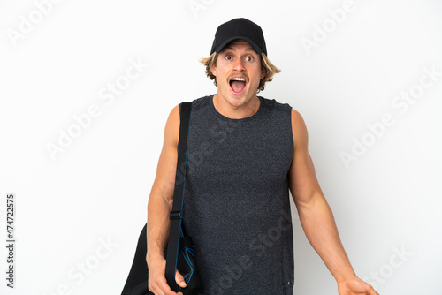 Young sport man with sport bag isolated on white background with surprise facial expression