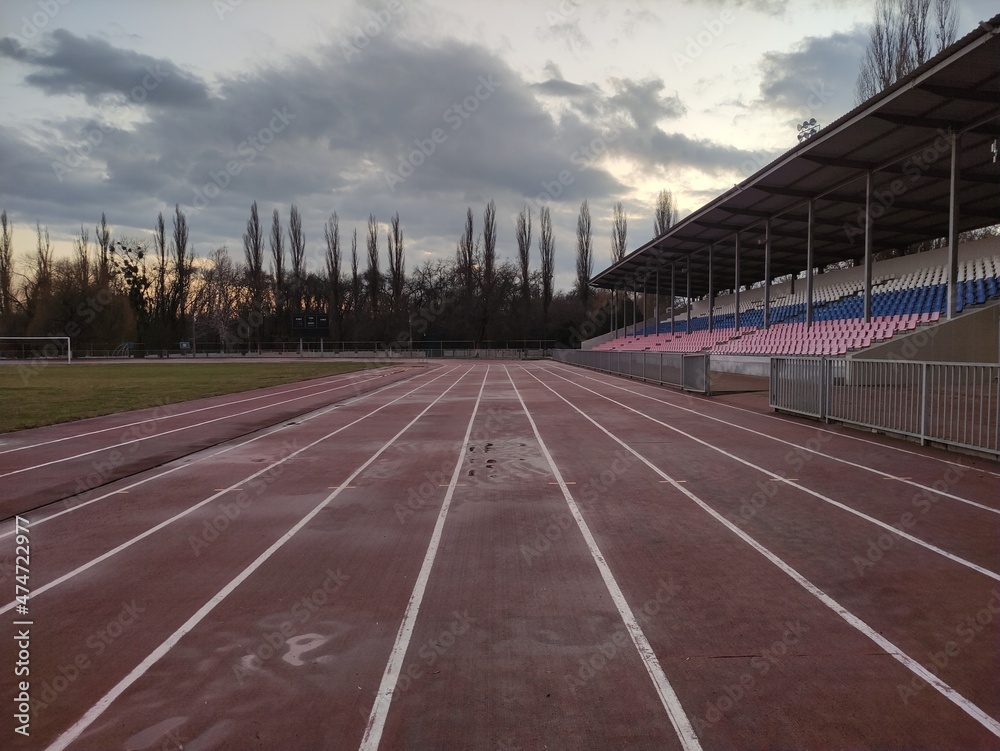 Running tracks in the stadium in evening in winter