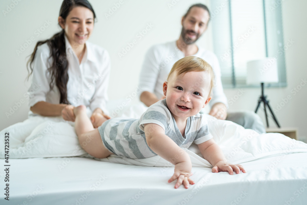 Portrait of Caucasian happy family smiling, look at camera in bedroom.