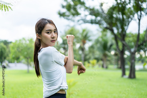 Asian young beautiful sport woman doing yoga workout outdoors in park. 