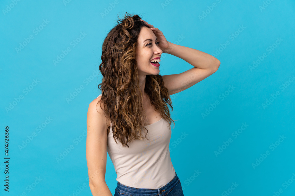 Young caucasian woman isolated on blue background smiling a lot Young caucasian woman isolated on blue background smiling a lot