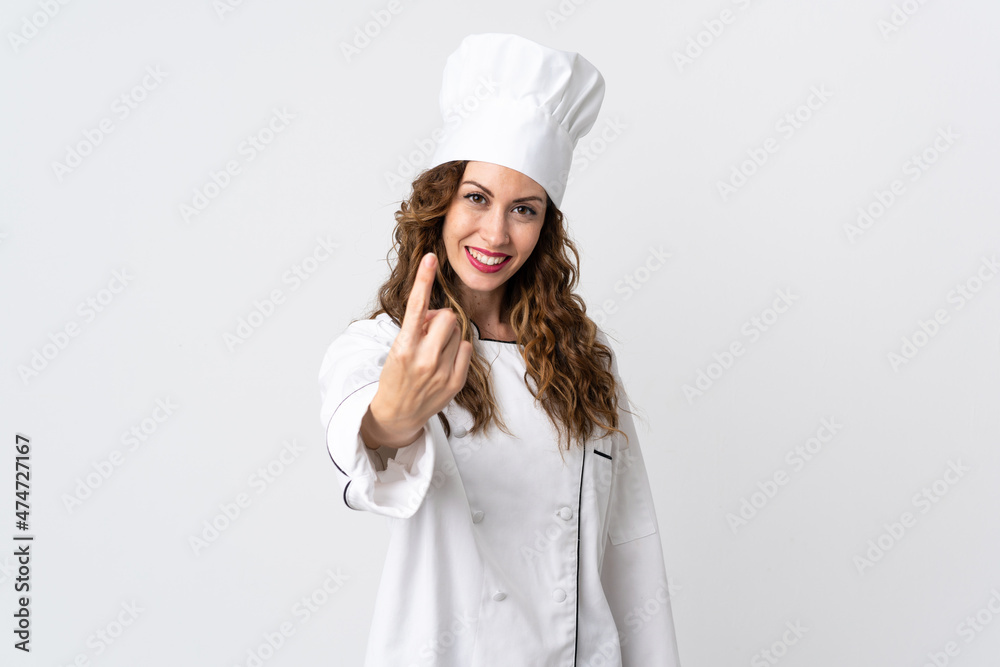 Young chef woman isolated on white background doing coming gesture Young chef woman isolated on white background doing coming gesture
