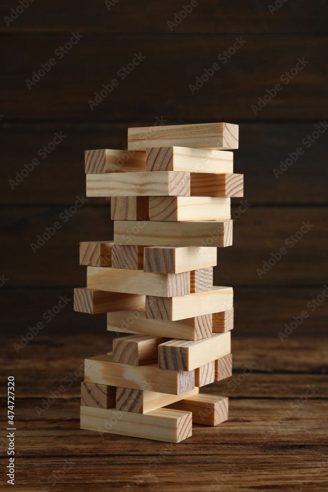 Jenga tower made of wooden blocks on table Jenga tower made of wooden blocks on table