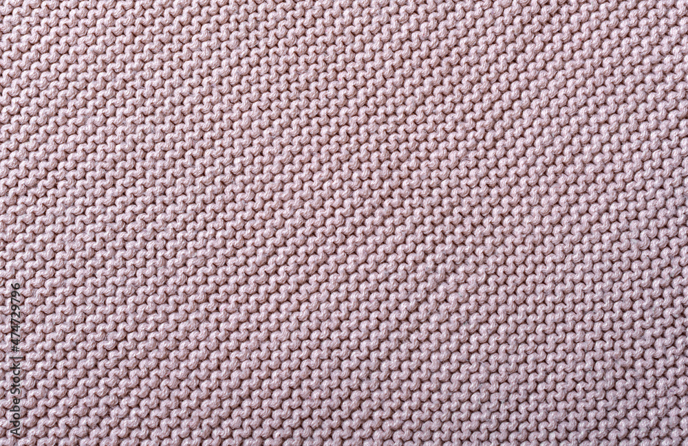Fototapeta premium The texture of a beautiful knitted fabric. The pattern is clearly visible.
