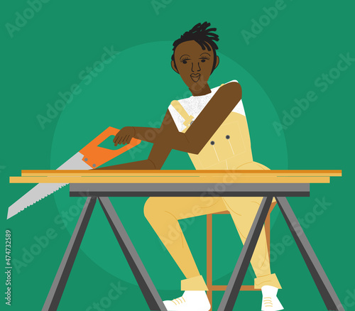 Gay woman carpenter using a wood saw  photo