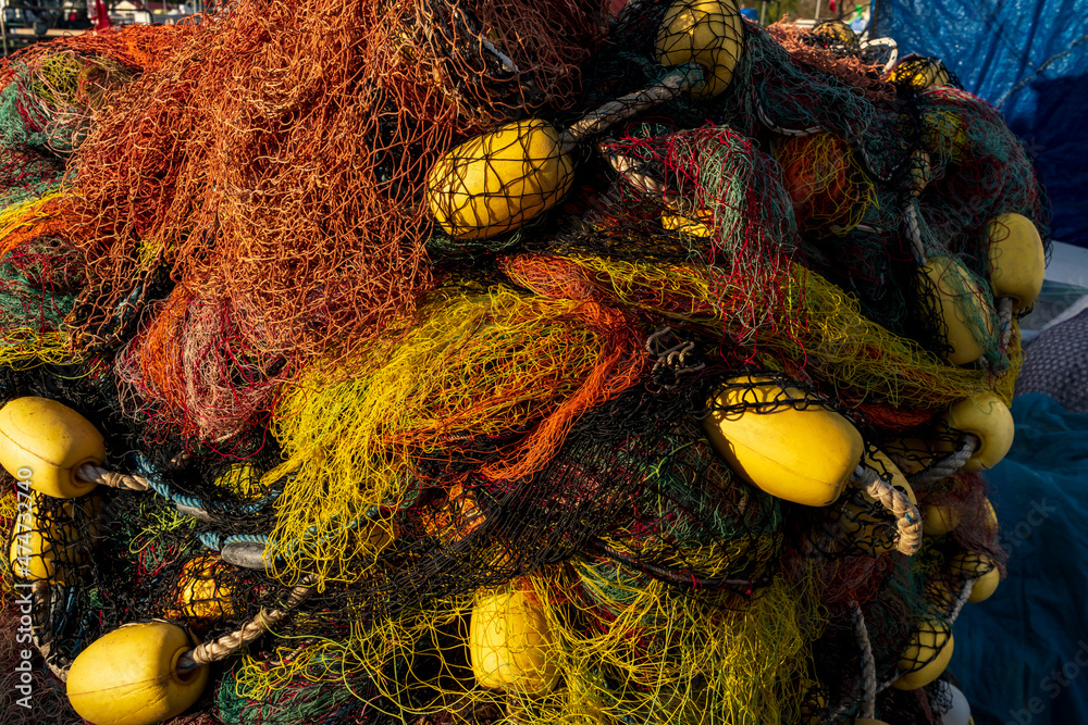 background of colorful fishing nets and floats. Pile commercial fish nets  and gill nets Stock Photo