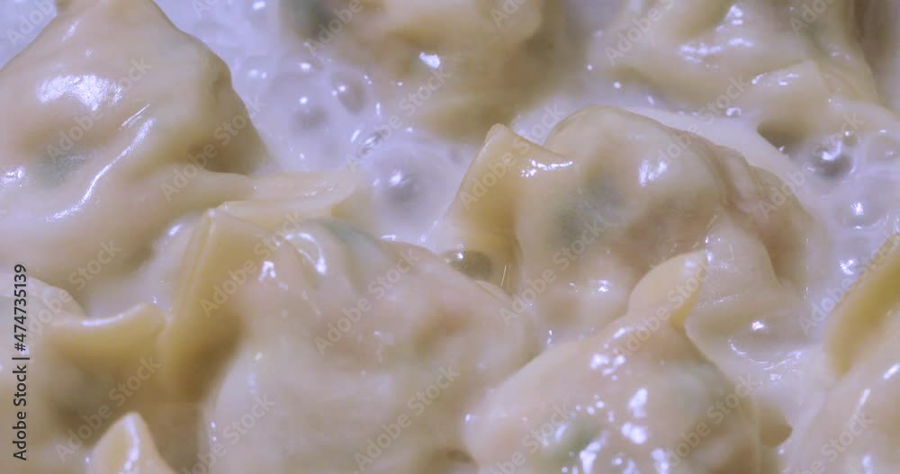 Fried dumplings are being cooked in the hot frying pan Fried dumplings are being cooked in the hot frying pan