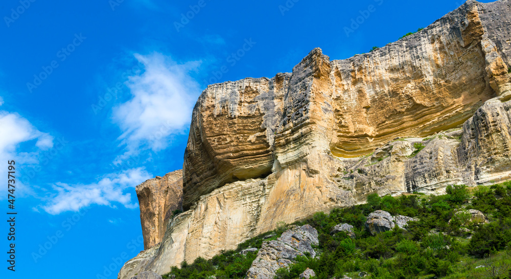 Bright rock against the blue sky at sunrise
