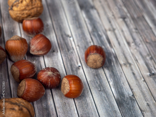 Hazelnuts on a wooden background.