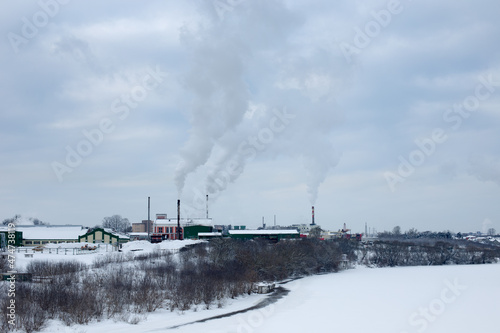 Industrial area of the city in winter, heat production photo