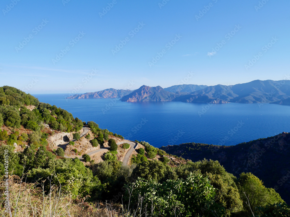 Scenic road D81 winding up to Calanche de Piana, UNESCO world heritage. Aerial view of Gulf of Porto. Corsica, France.