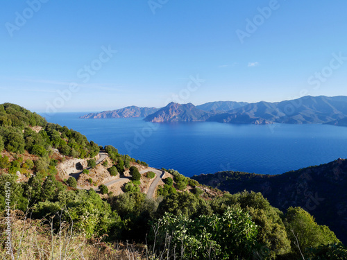 Scenic road D81 winding up to Calanche de Piana, UNESCO world heritage. Aerial view of Gulf of Porto. Corsica, France. photo