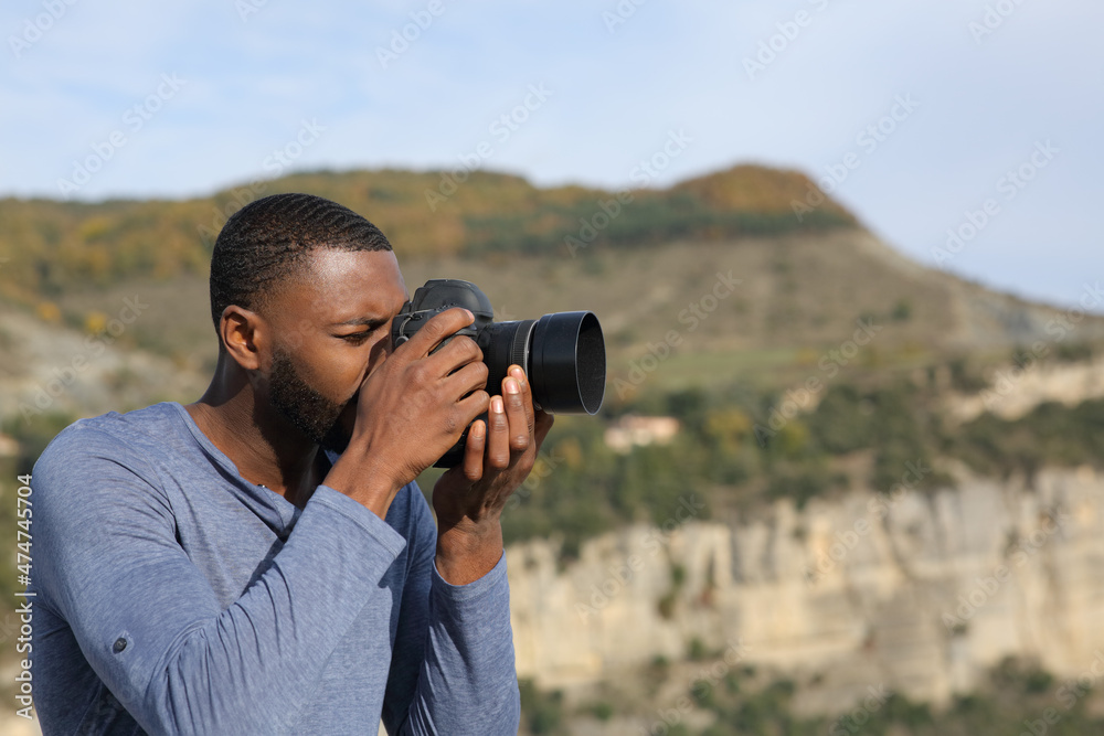 Man with black skin taking photos with dslr camera Man with black skin taking photos with dslr camera