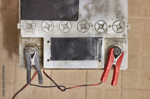 Charging a car starter battery in a garage photo