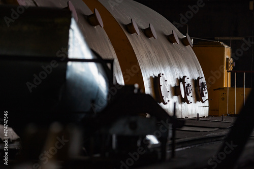 Electric power station. Close-up of steam turbine body. Black background. photo