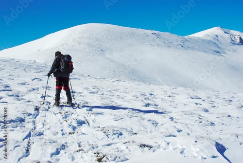climber climbing snowy mountain, with professional equipment